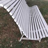 Old garden bench with metal legs and wooden slats