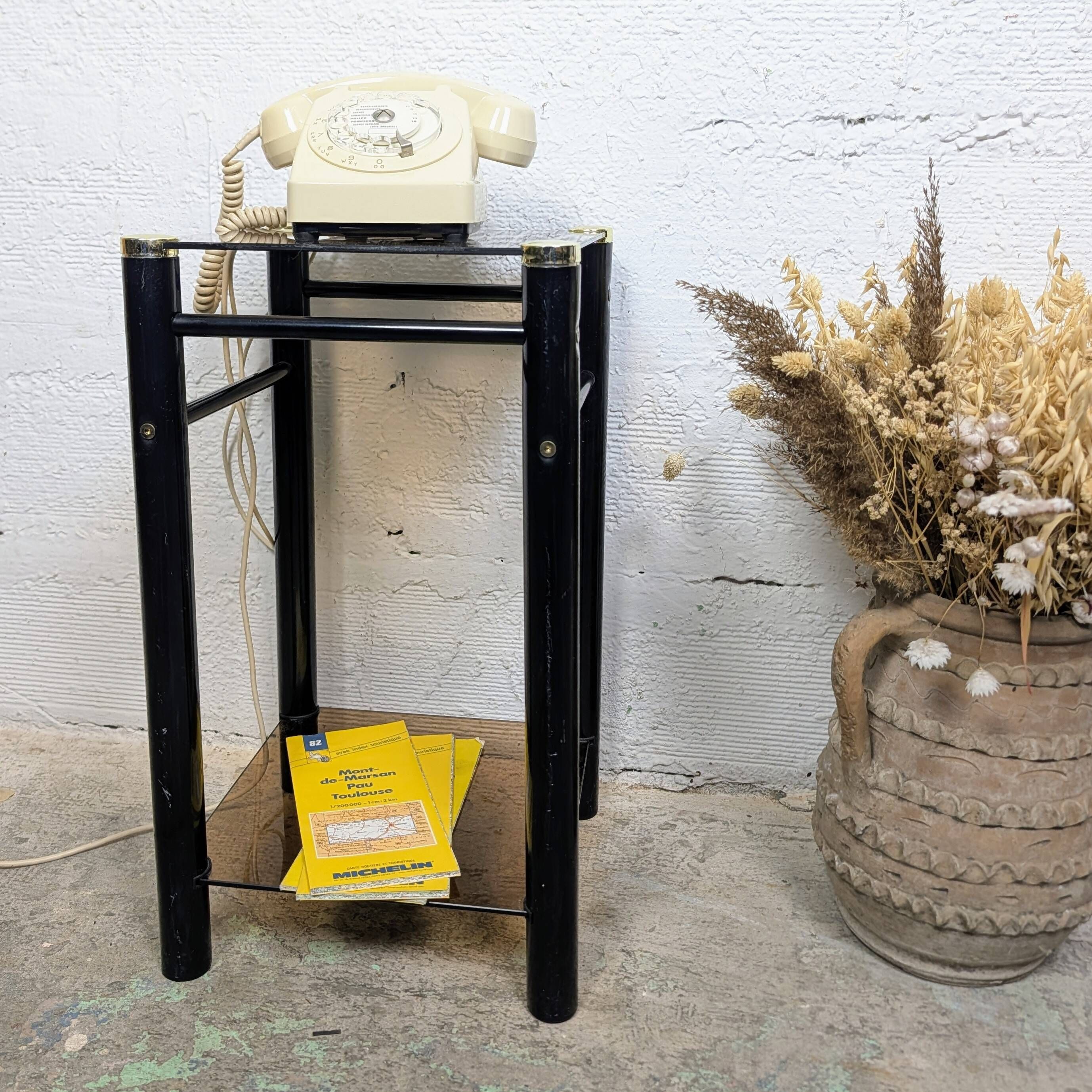Vintage side table with two smoked glass tops and black metal.