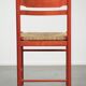 Nice red vintage wooden chair from the 1970s with a woven wicker seat