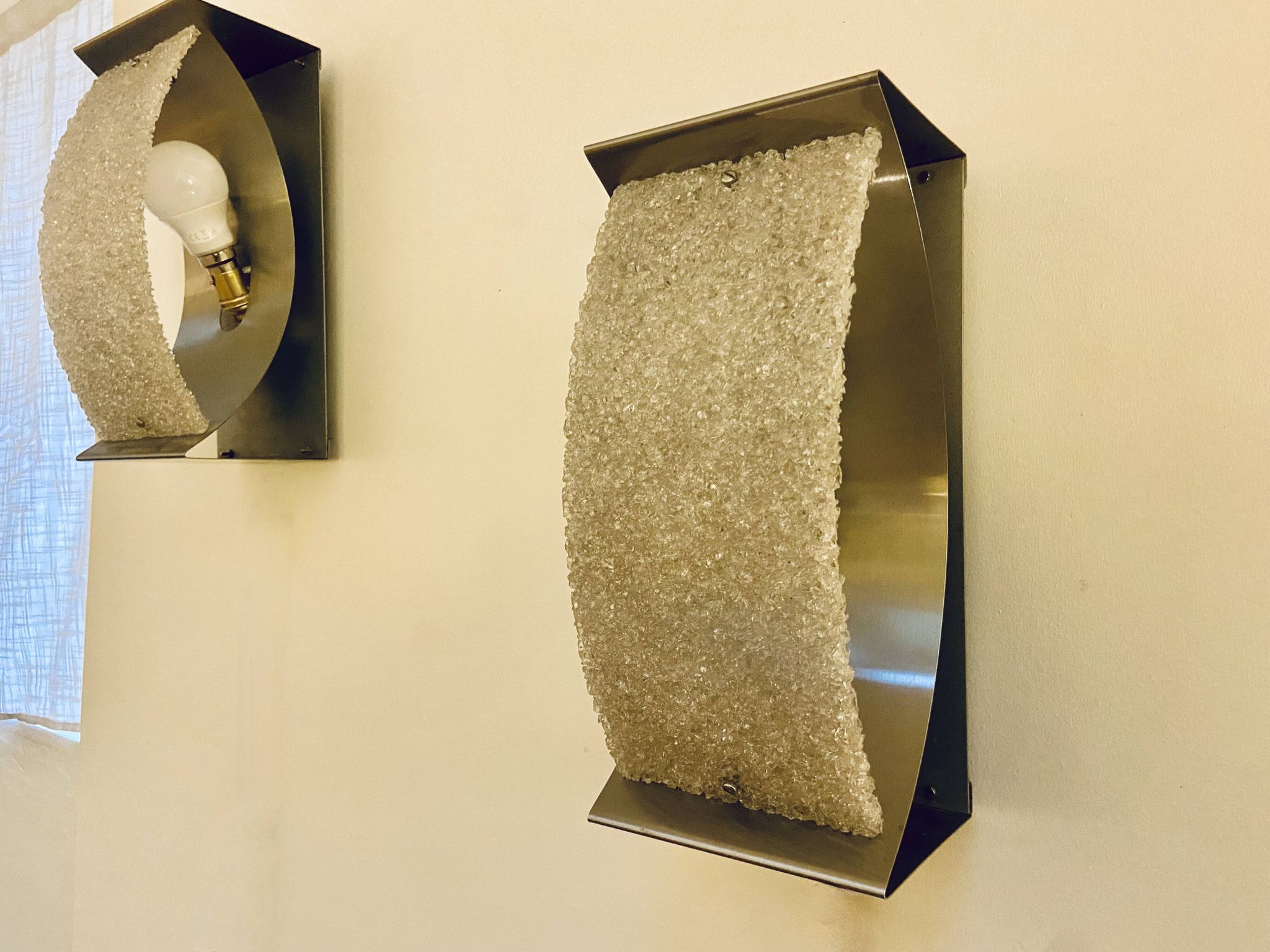 Pair of brushed steel and perspex wall lights, circa 1970.