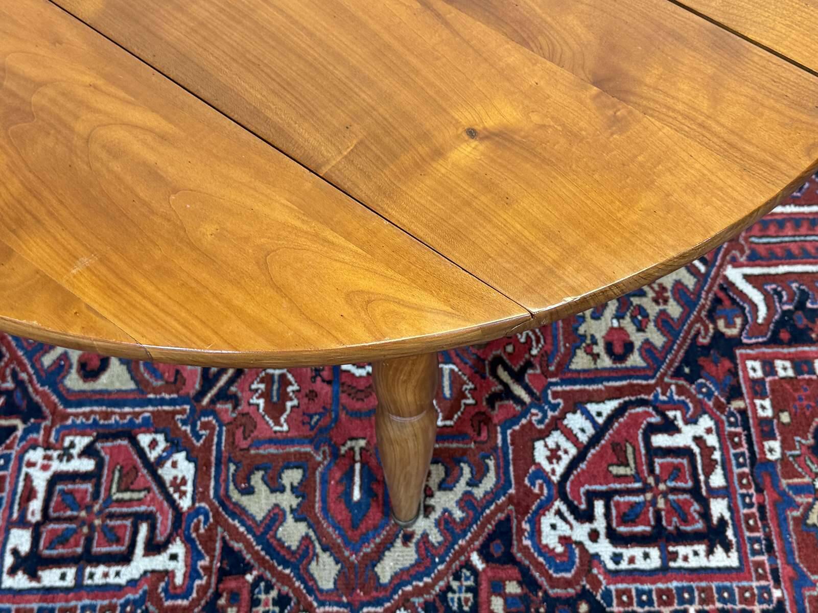 Round cherry wood table, 6 feet, Louis Philippe style with 2 extensions.
