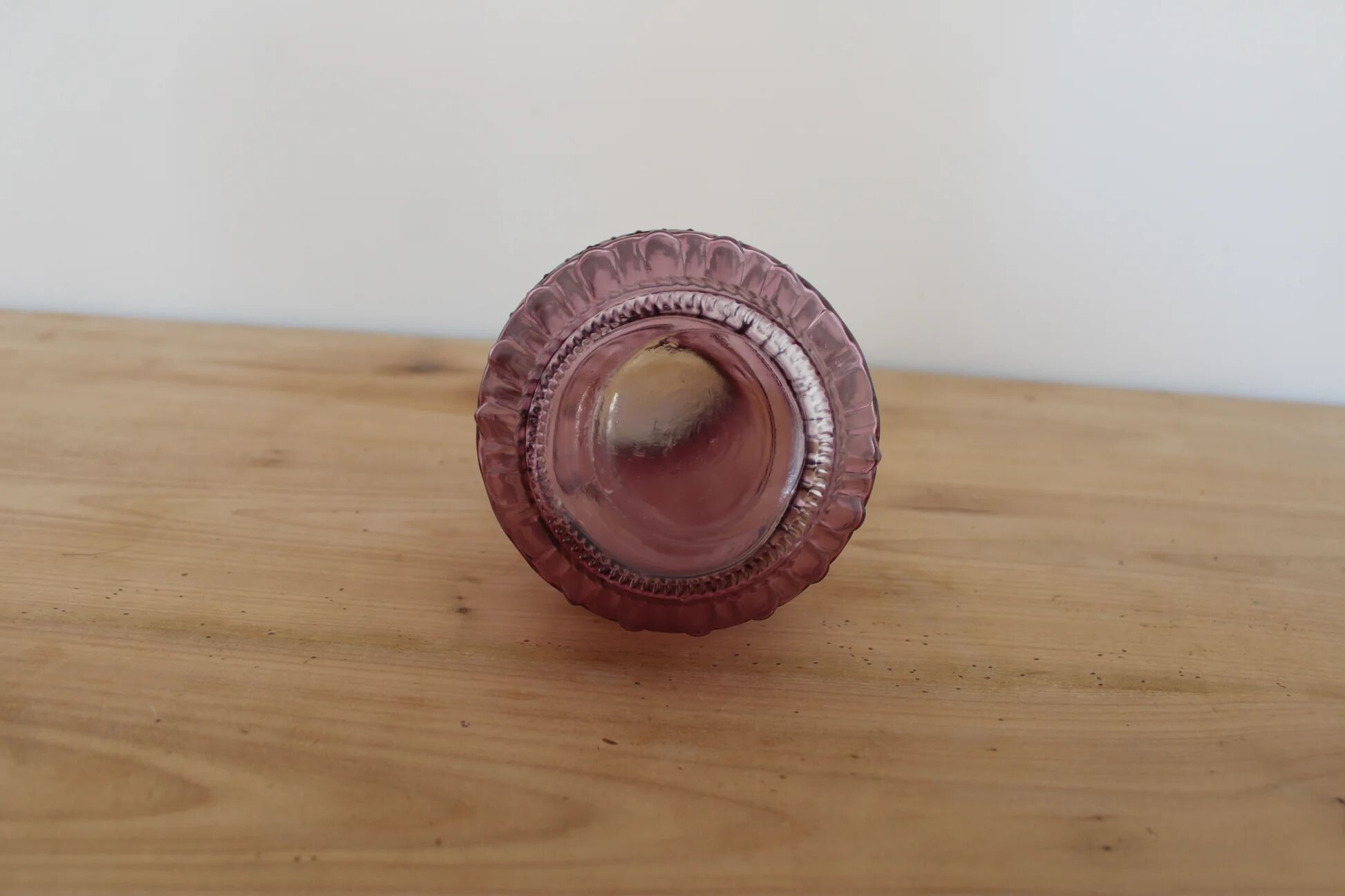 Vintage pink pressed glass carafe – retro decorative bottle with wooden stopper.