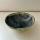 Green bowl signed with an eye