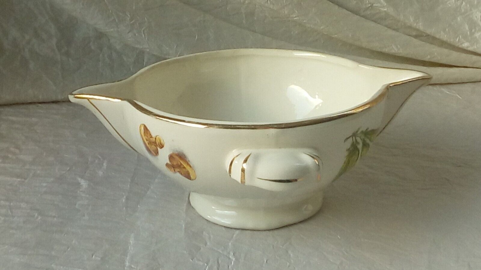 Sauceboat in earthenware decorated with four seasons vegetables.