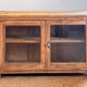 Old wooden buffet with a glass front in raw wood