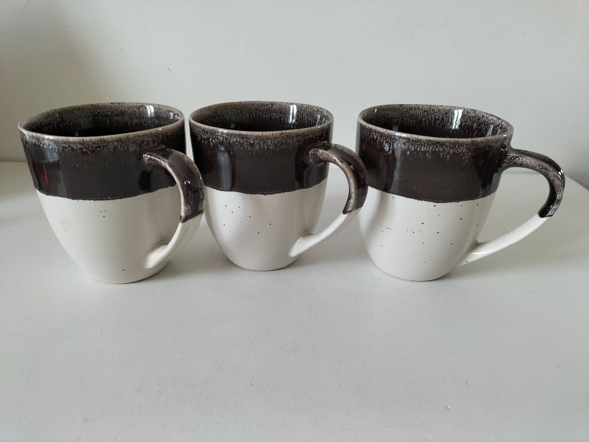 Set of three two-tone mugs, glazed stoneware, café workshop style.