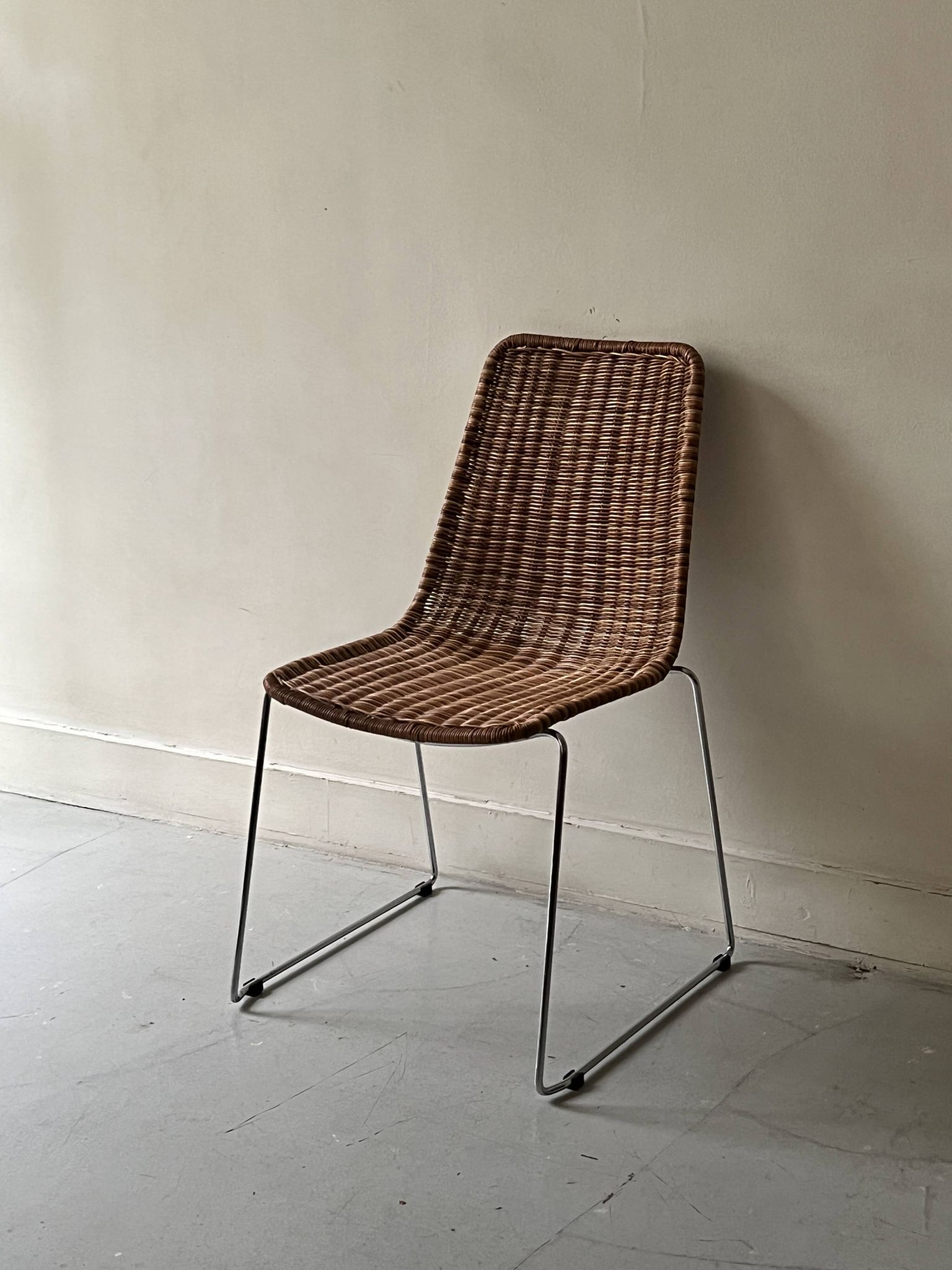 Chair design in rattan, woven wicker and chrome wire metal.