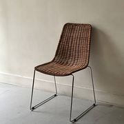 Chair design in rattan, woven wicker and chrome wire metal.