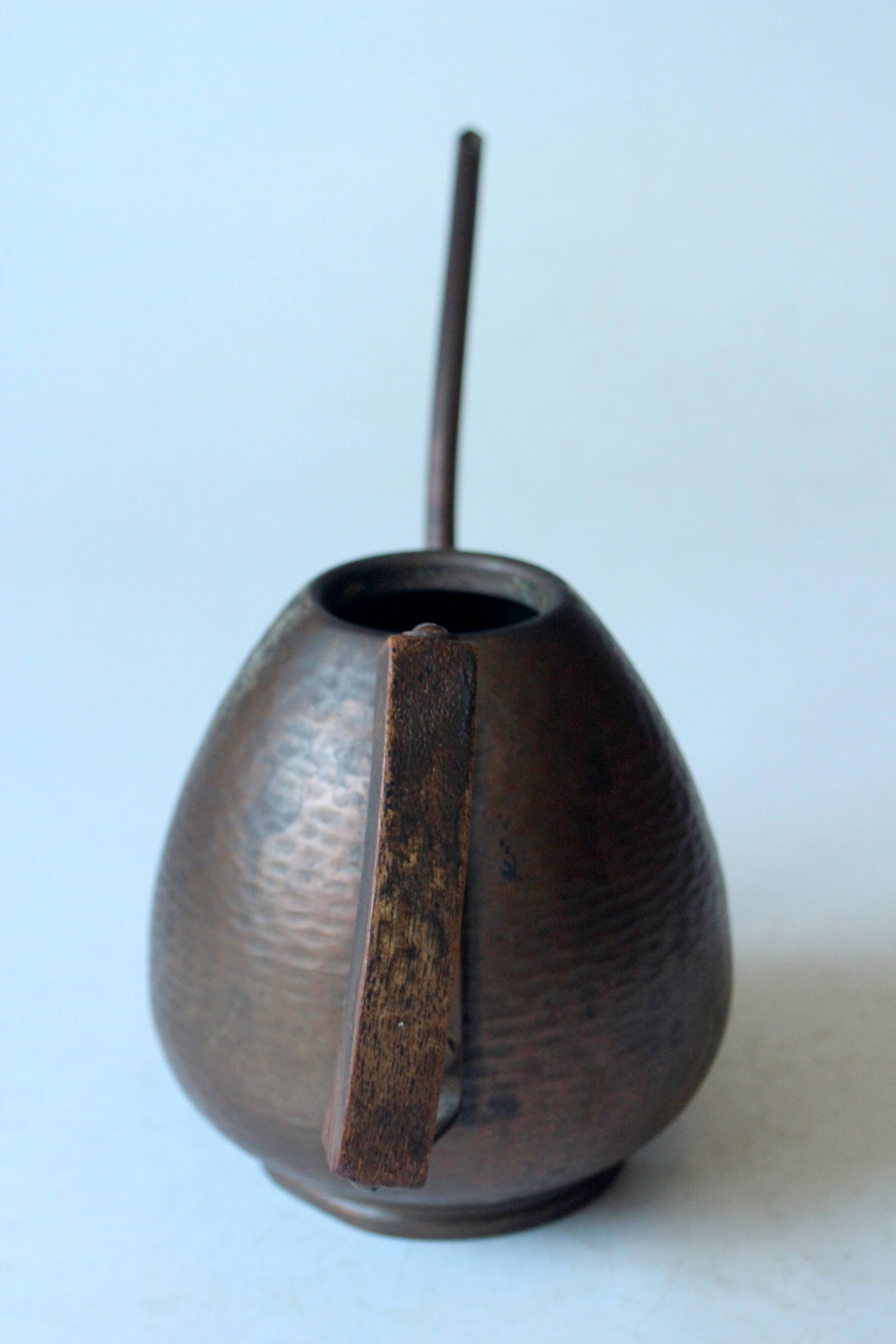 Old copper watering can with wooden handle, complete usuable, vintage from the 1960s