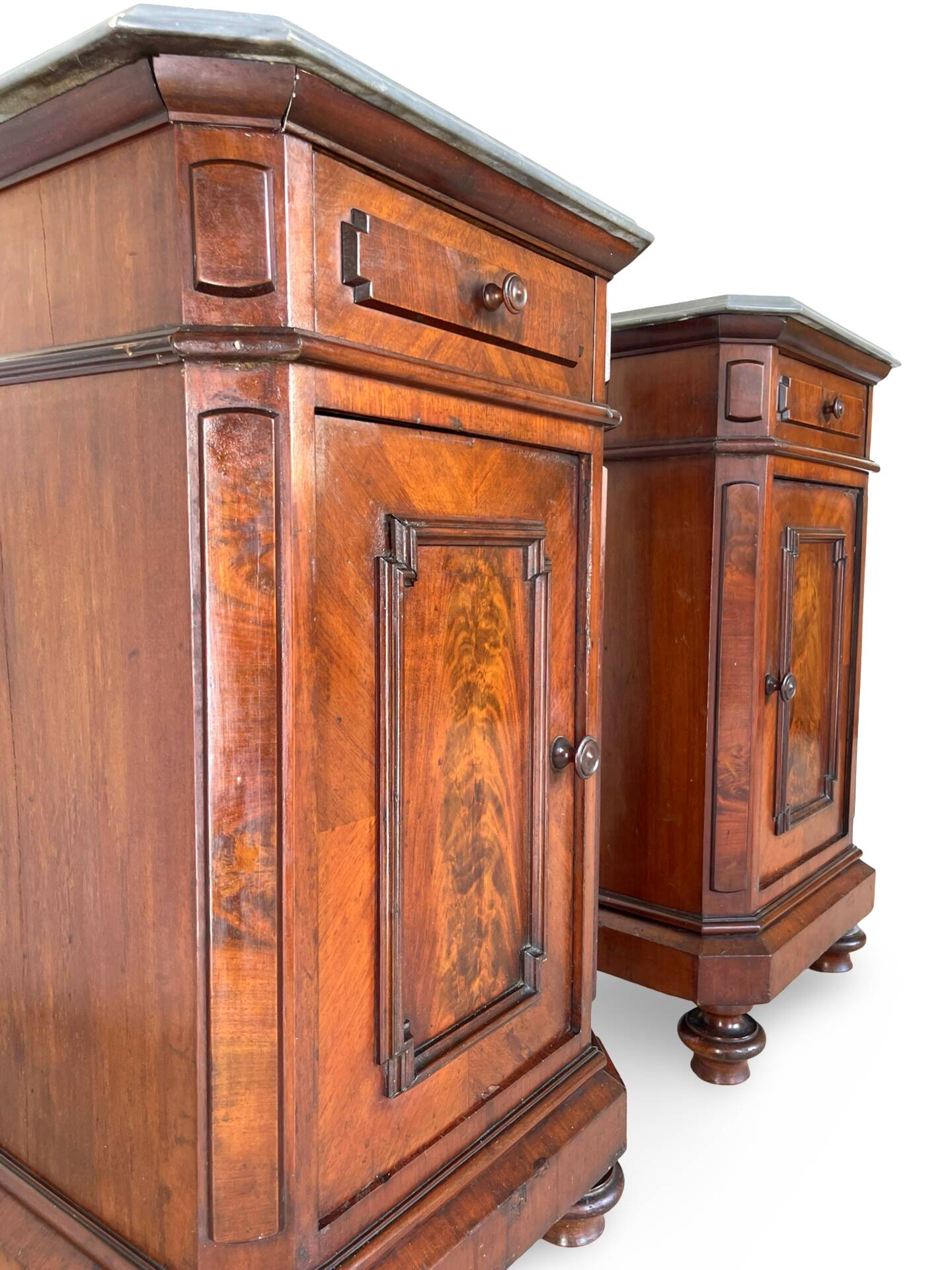 A pair of antique walnut bedside tables from the 1890s.