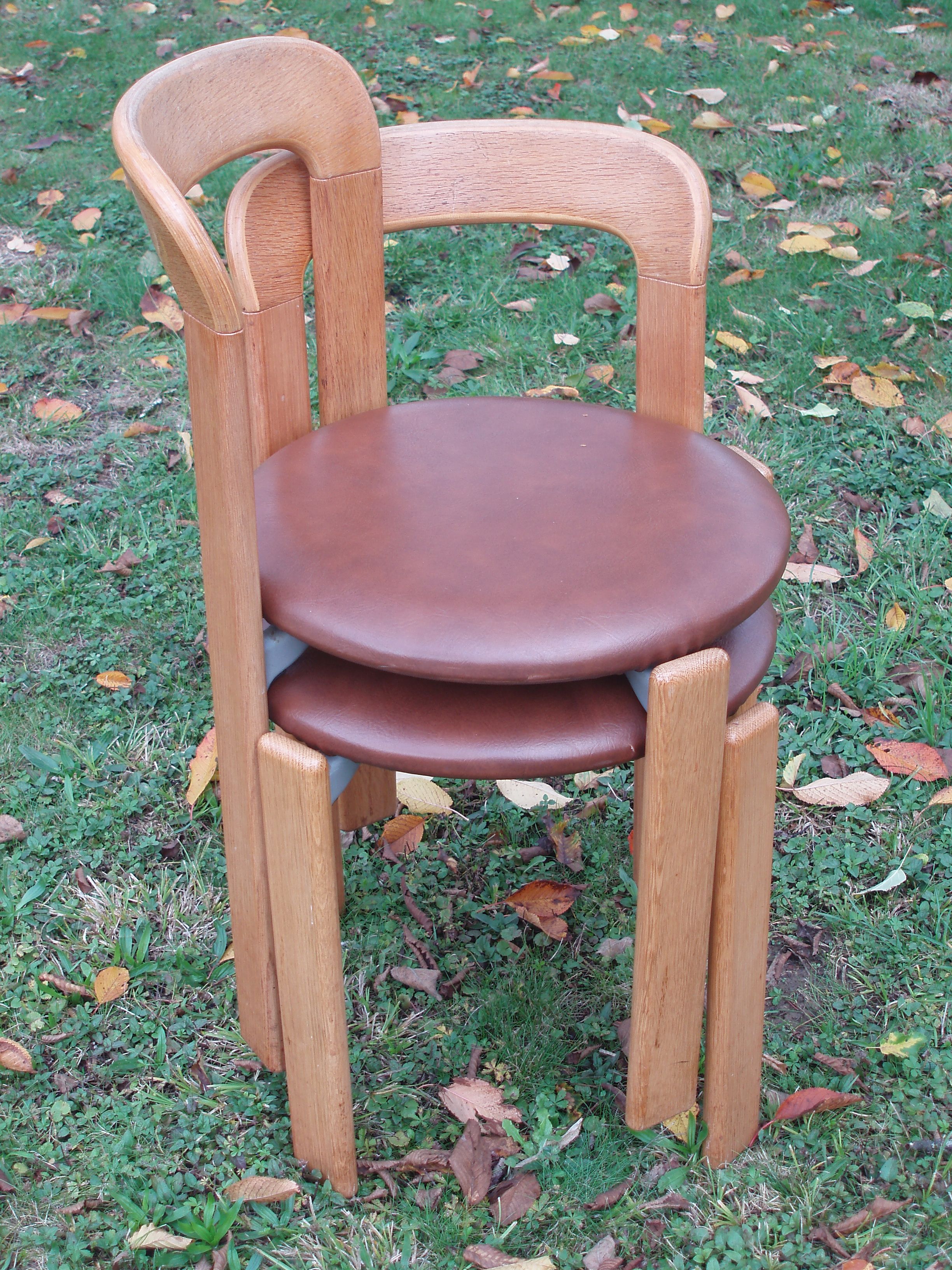 Pair of chairs by Swiss designer Bruno Rey in wood and brown skai