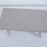 Small vintage wooden bench renovated in pinkish beige