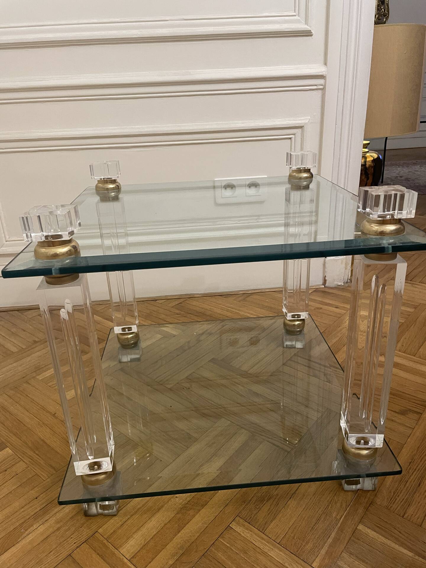 Glass side table with gold decorations.