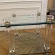 Glass side table with gold decorations.