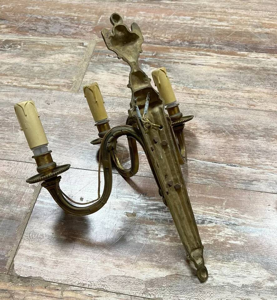 Pair of Louis XVI style gilt bronze wall lights with two light arms, 20th century