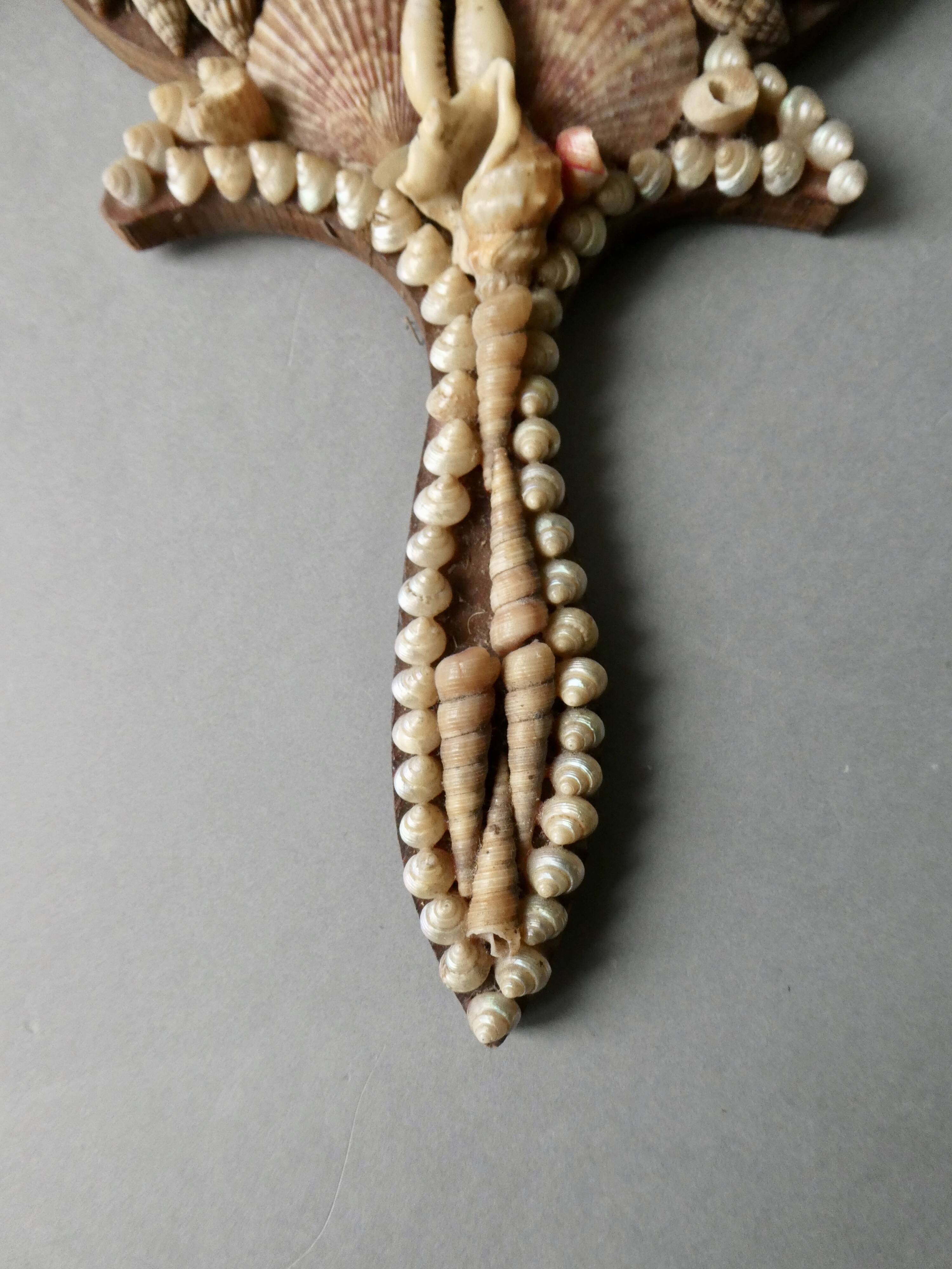 Wall mirror, hand facing in wood and shells