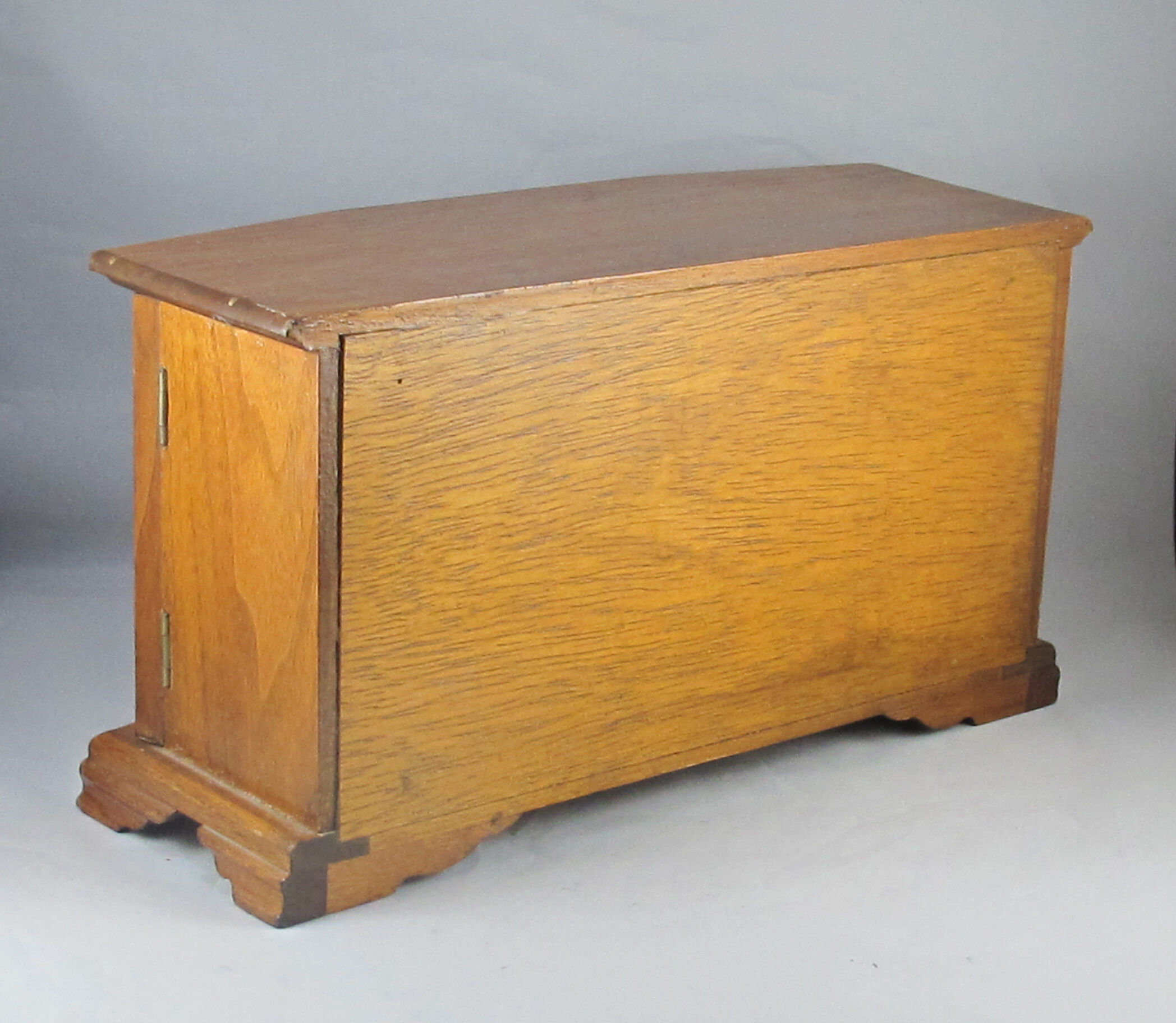 Wooden jewelry box in the shape of a chest of drawers