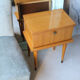Modernist bedside table from the 1950s with compass legs.