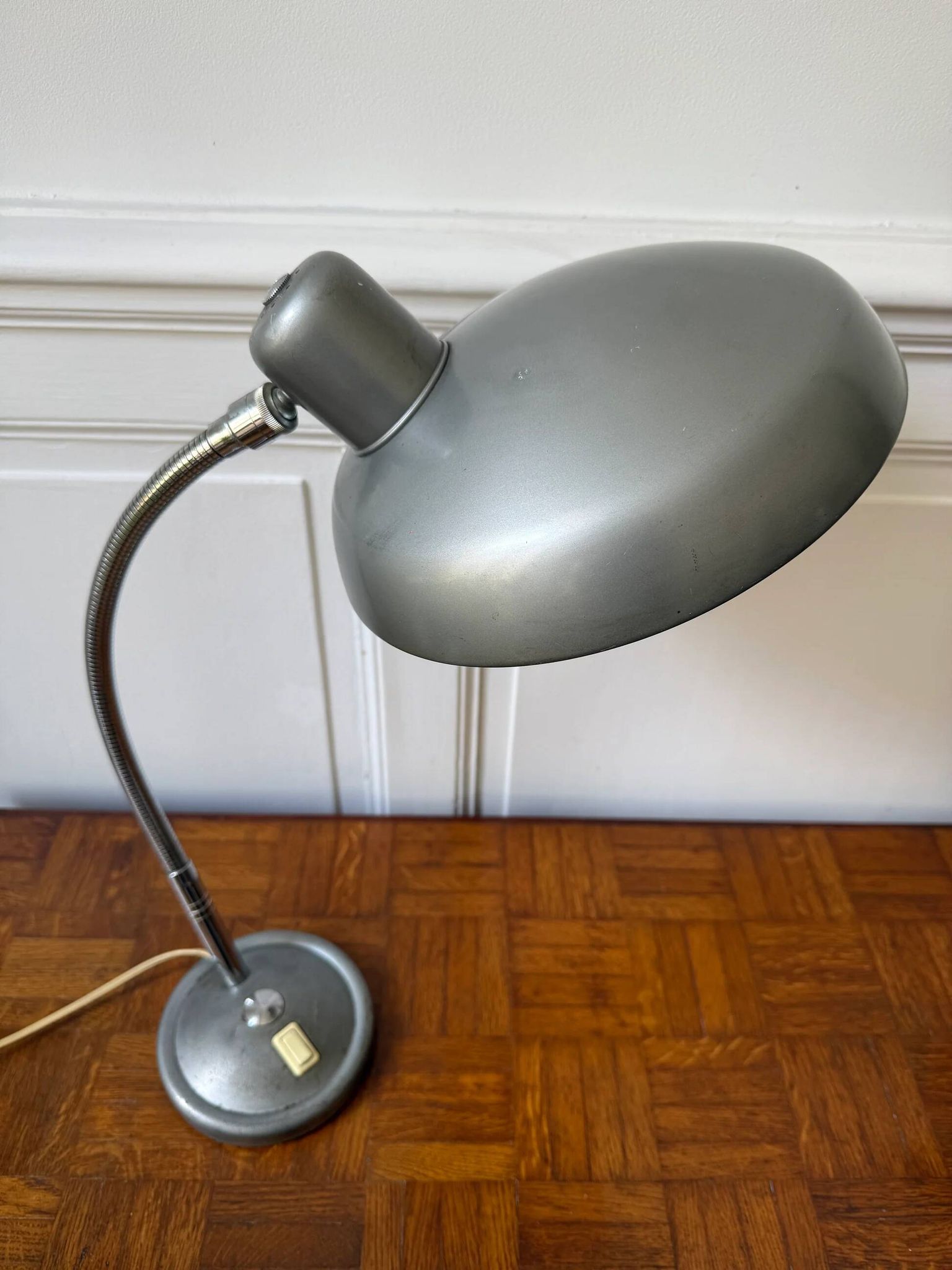 Industrial metal workshop lamp with a gooseneck.