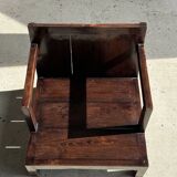 Small low armchair in varnished brown wood