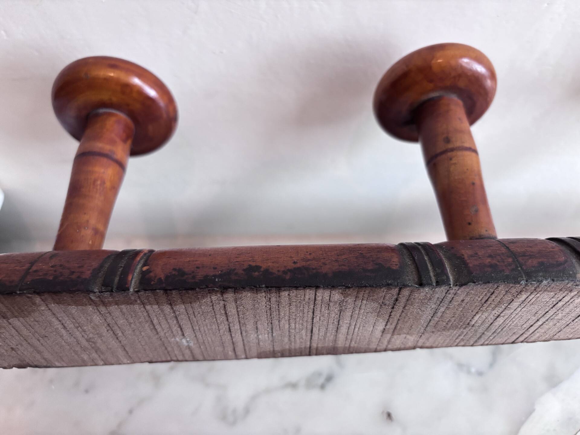 Wall-mounted coat rack with 8 turned wooden hooks in faux bamboo style.
