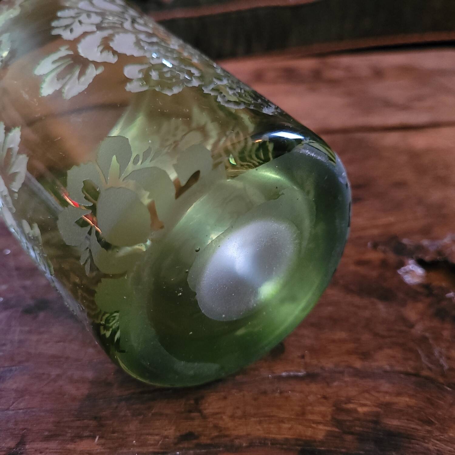 Green gradient blown glass vase with engraved floral decoration.