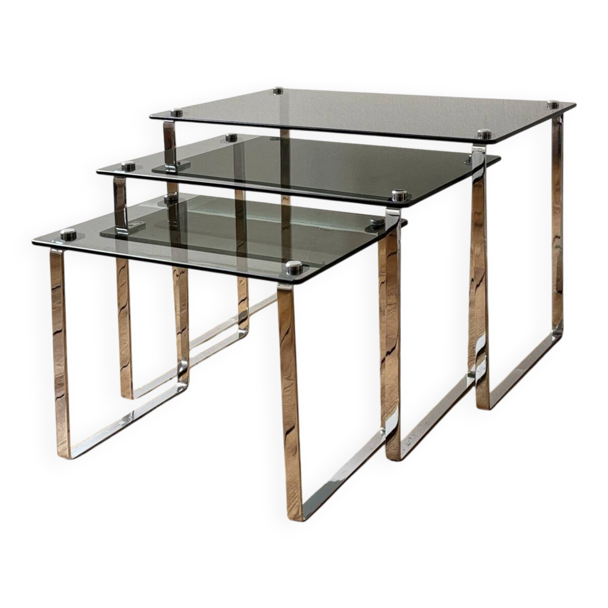 Nest of coffee tables in chrome with smoked glass top.