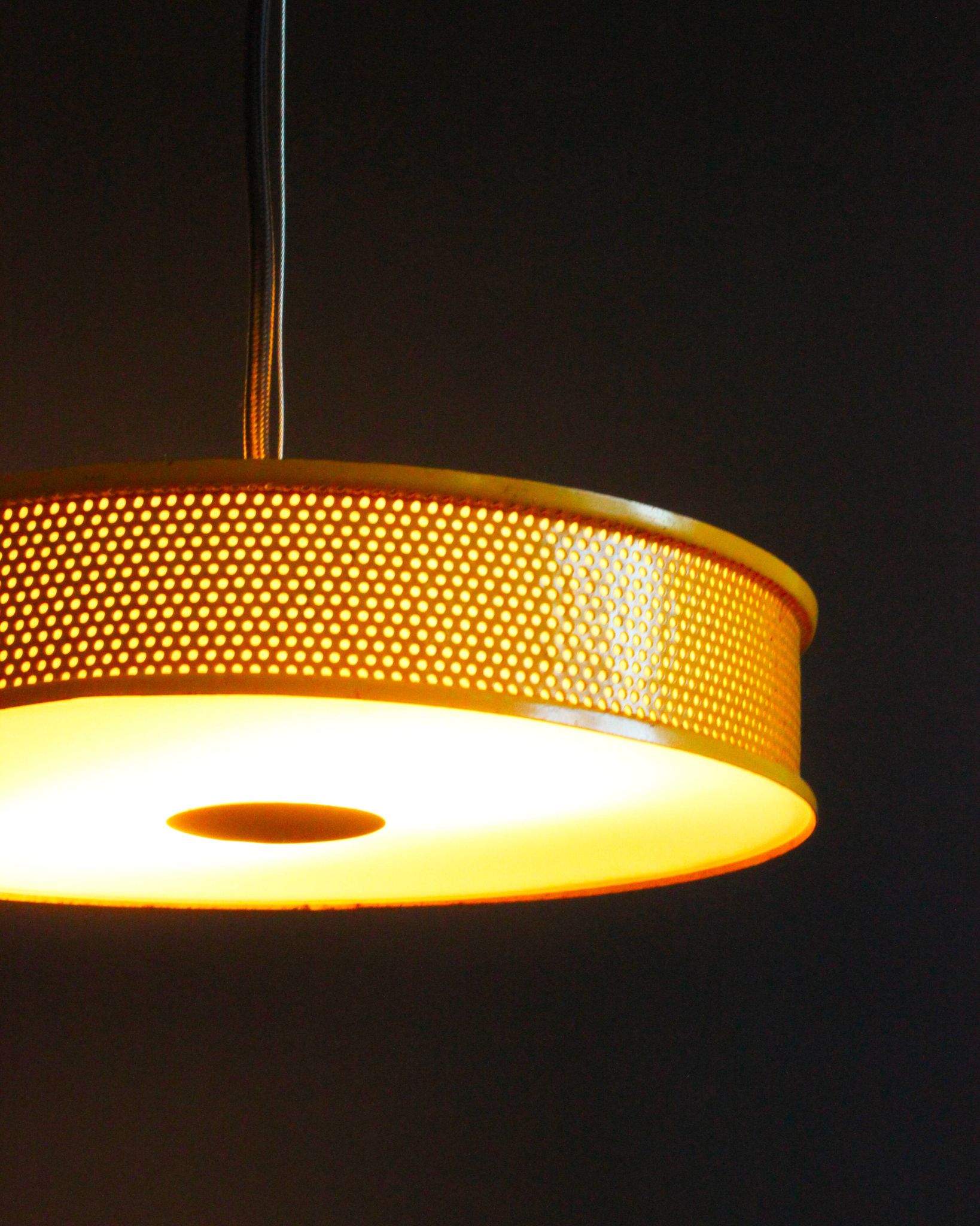 Yellow lacquered perforated metal pendant, in the style of Matégot or Biny.