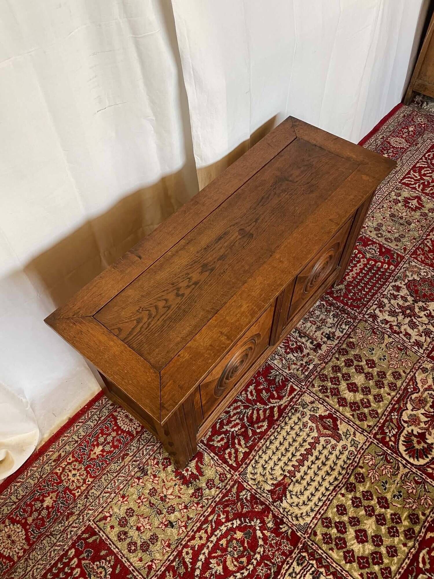 Small antique oak chest with carved panels.
