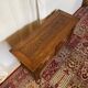 Small antique oak chest with carved panels.