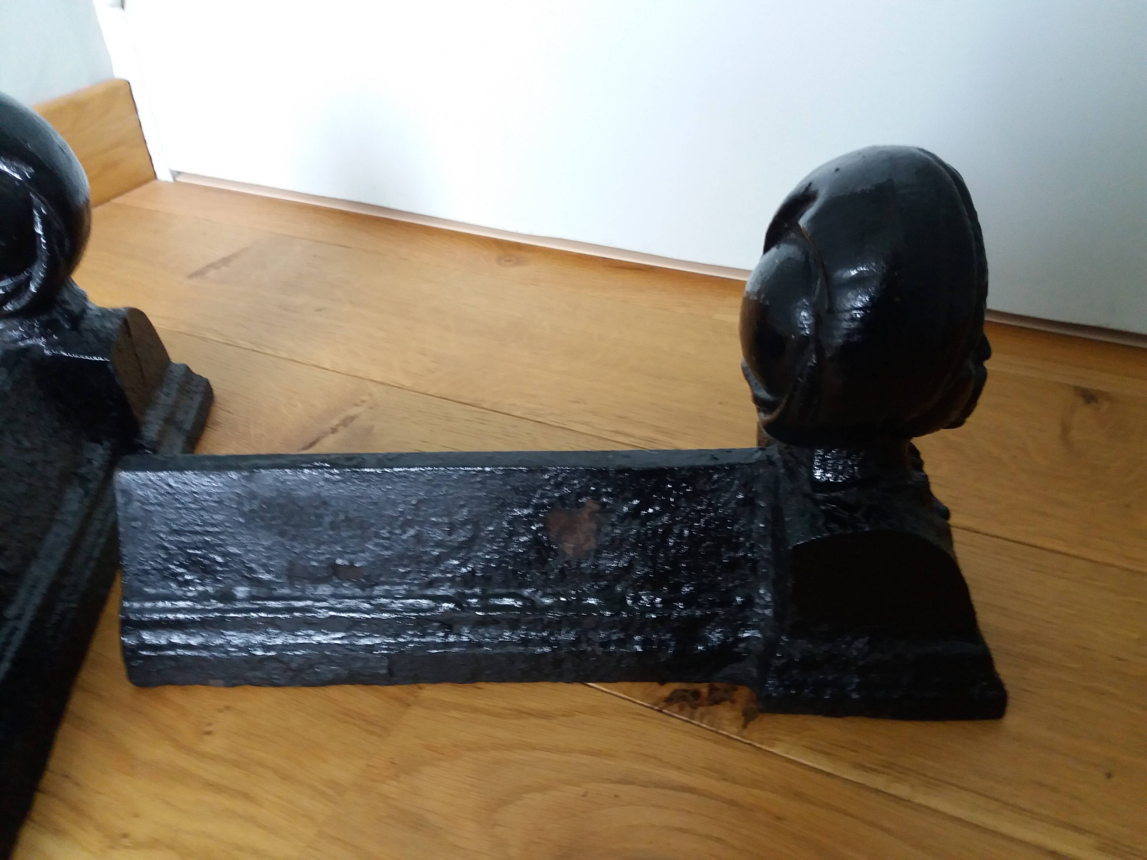 Cast iron andirons with character heads