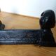 Cast iron andirons with character heads