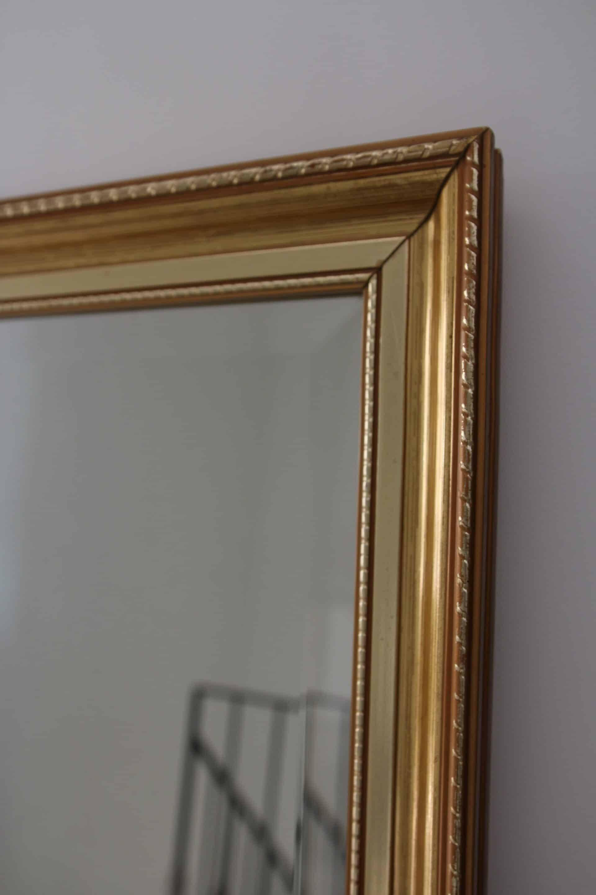 Large beveled mirror in carved wood