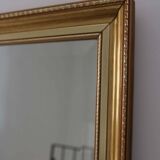 Large beveled mirror in carved wood