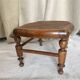 Low wooden stool with caning, footrest.