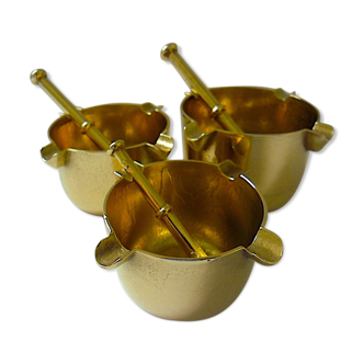 Three "vintage" bronze ashtrays with golden natural patina forming mortars with their drumsticks
