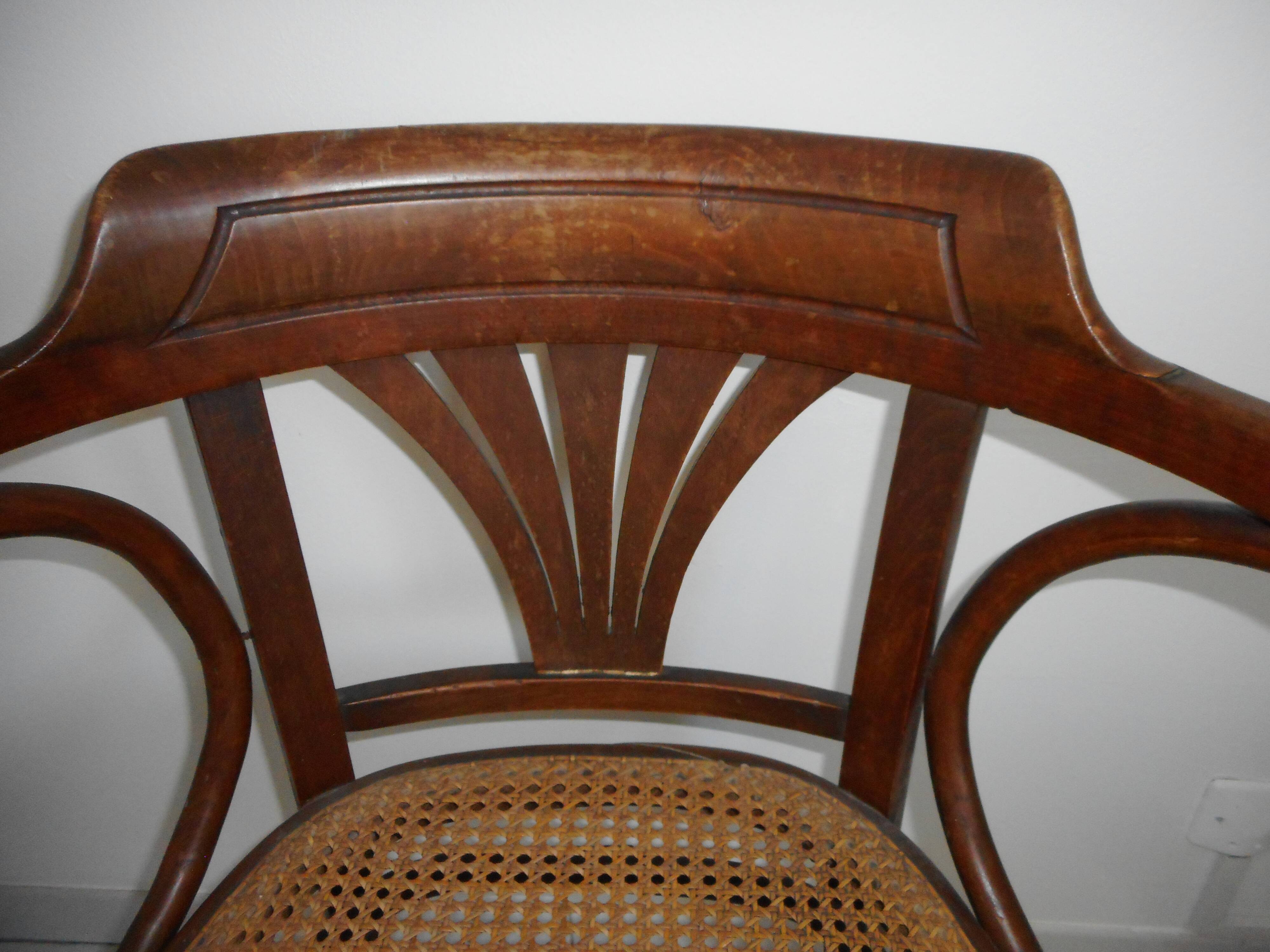 Wooden armchair with caned base