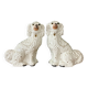 Pair of Staffordshire-type dogs in white and gold ceramic