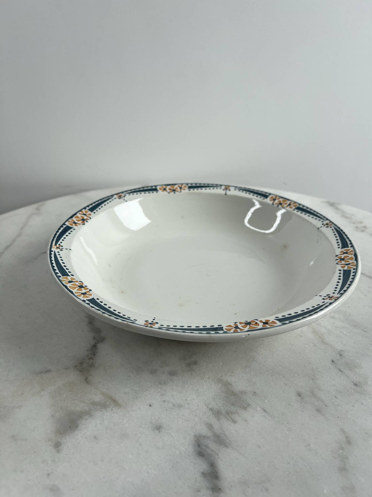 Longwy salad bowl with blue and orange floral decoration.