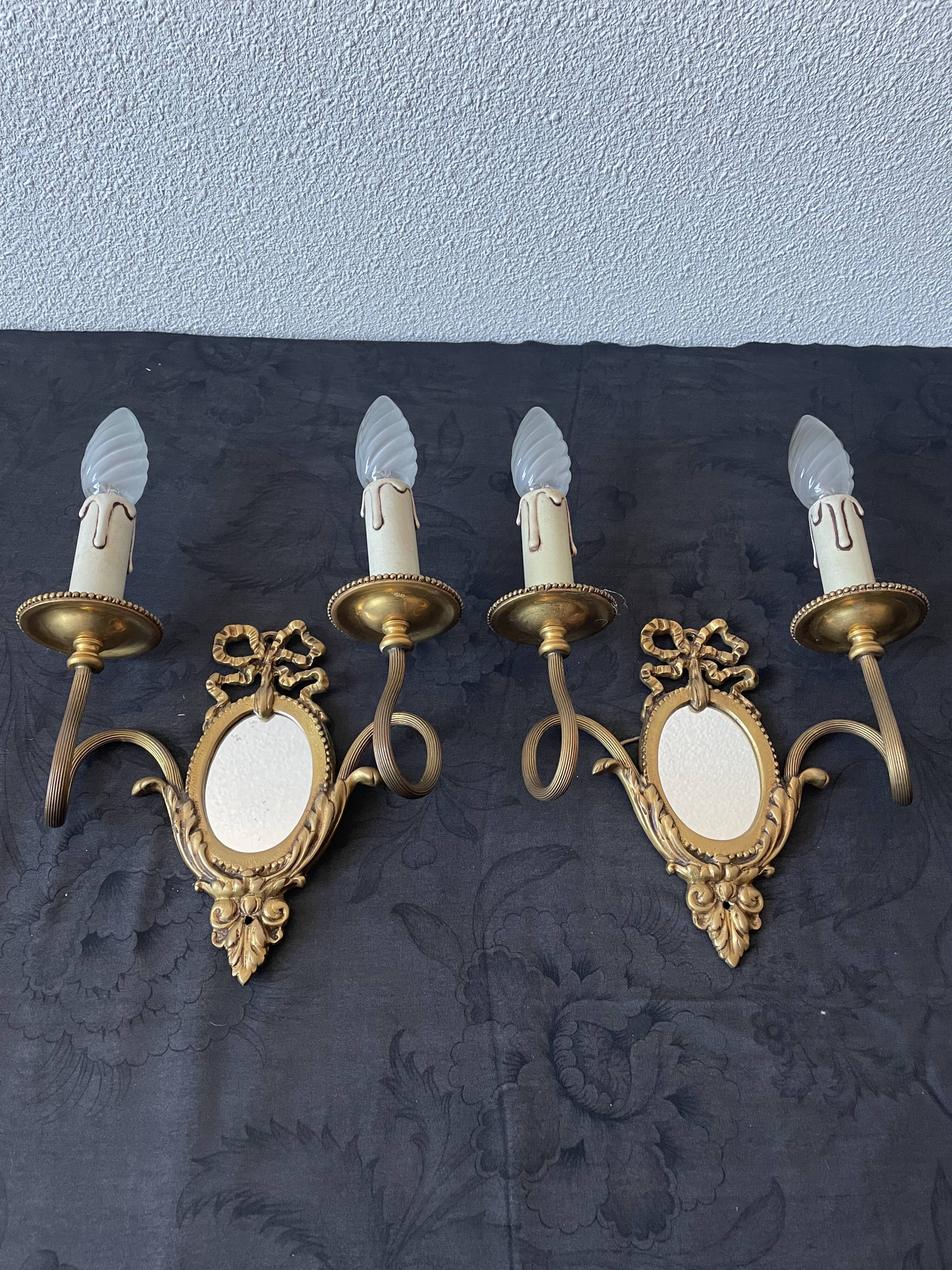 Pair of bronze wall lamps with mirror