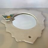 Ceramic mirror with serrated edge and a flower