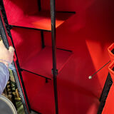 Contemporary wardrobe in black faux leather with diamond pattern and gold handles.