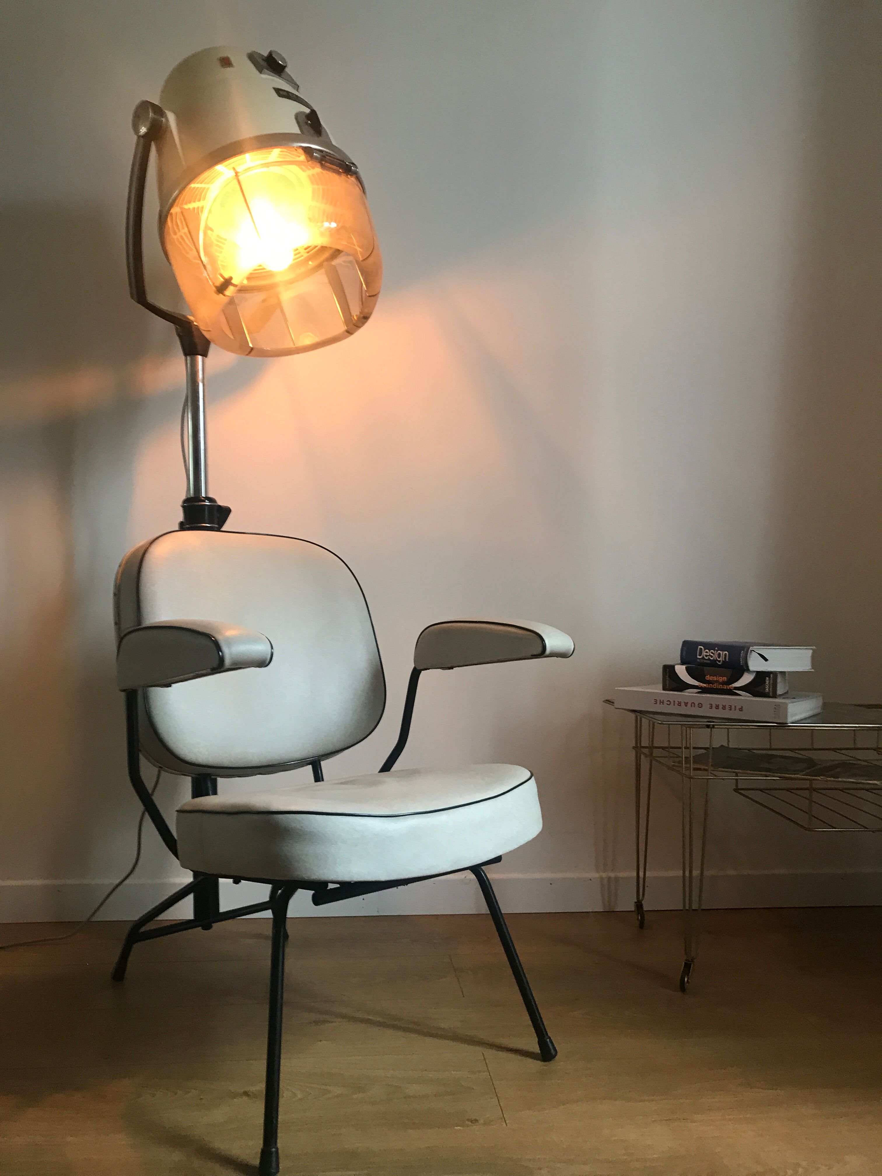 Vintage hairdresser's armchair with helmet transformed into a lamp