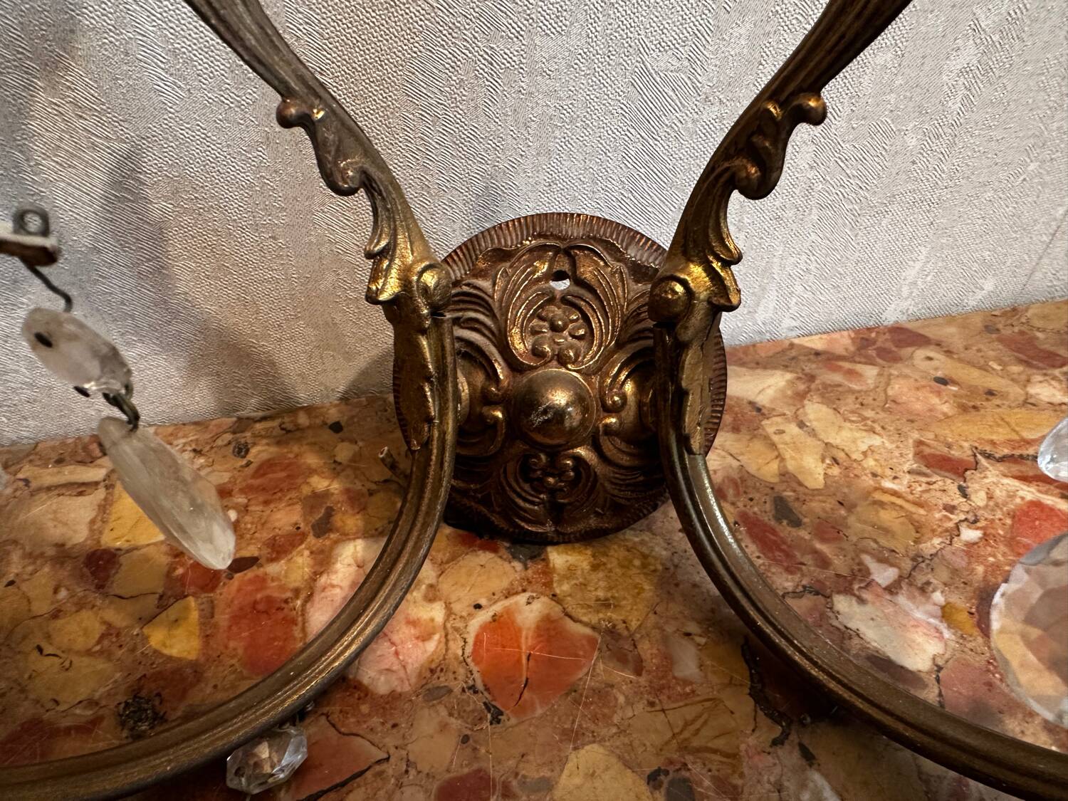 Pair of Louis XV style wall sconces in gilded bronze with glass pendants.