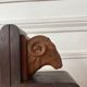 Pair of carved wooden bookends in the shape of ram's heads.