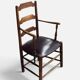 Antique rustic armchair in walnut and leather, 18th century.