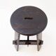 Vintage black-stained wooden tripod stool with mortise joints.