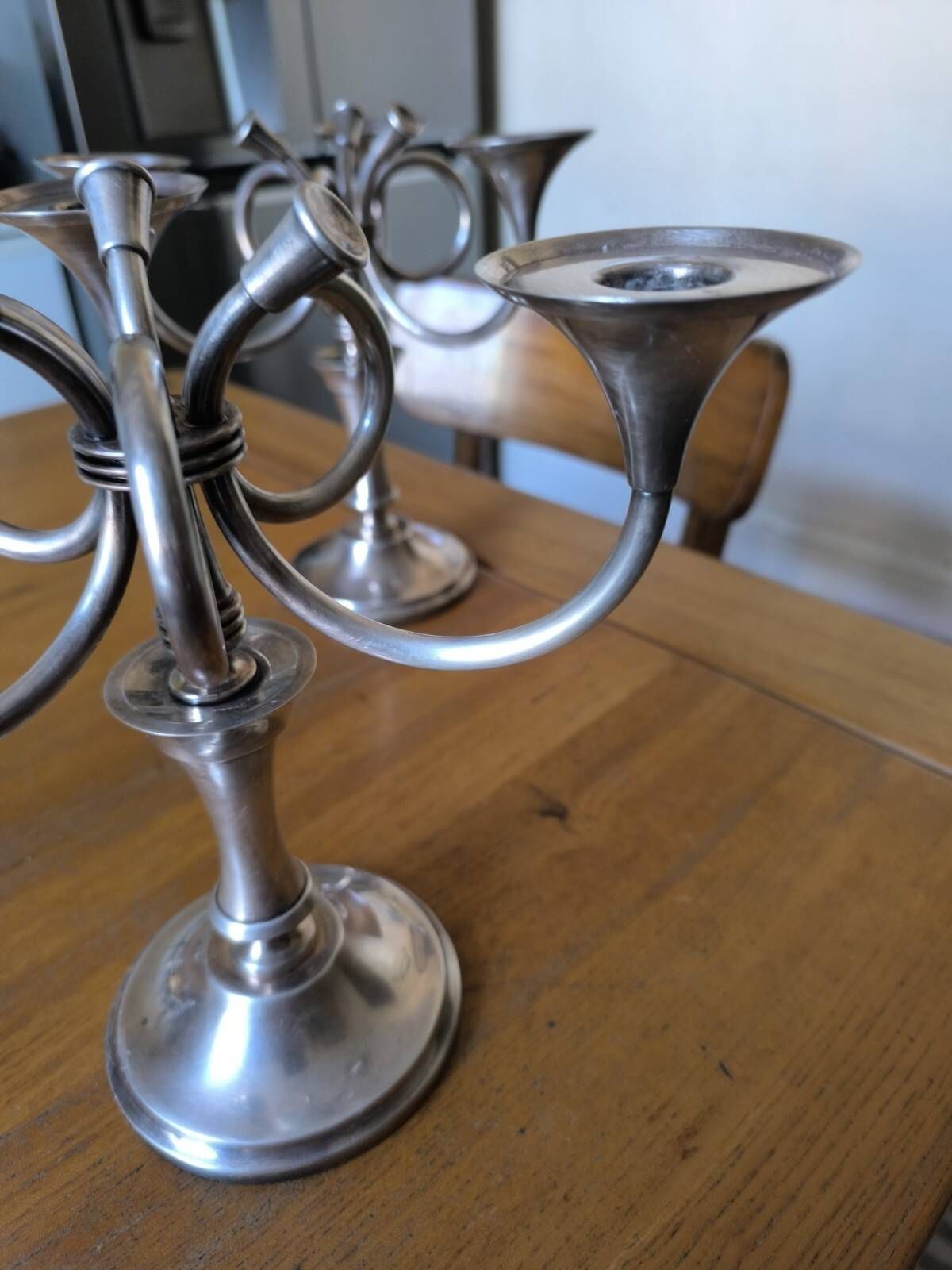 Ercuis pair of candlesticks model Cheverny in silver-plated metal with hunting horn decoration.