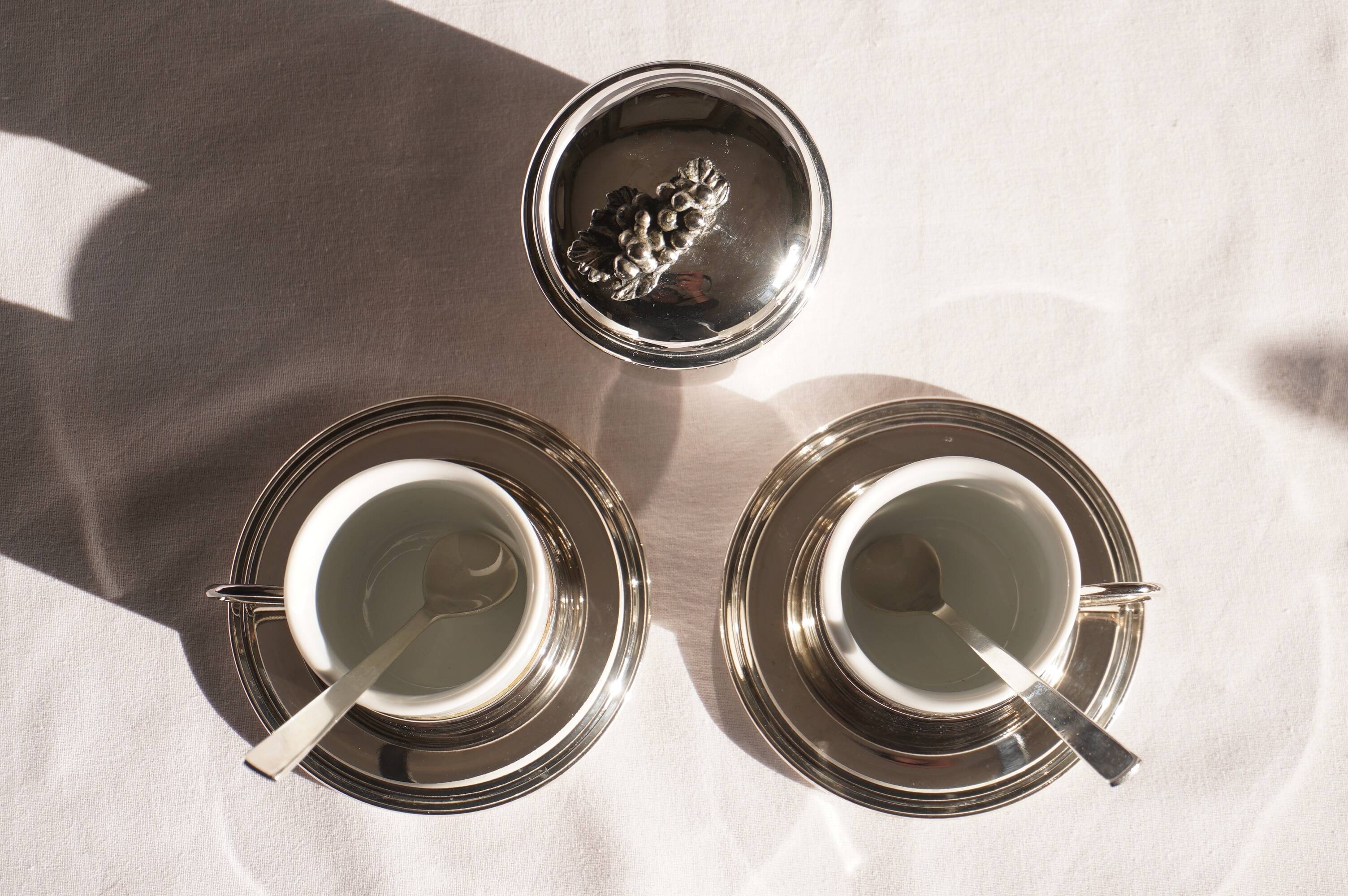 Silver-plated metal coffee service with a grape design.