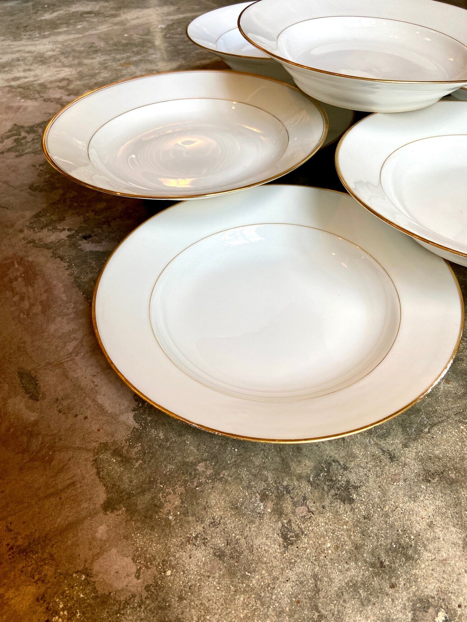 9 hollow plates in white and golden Limoges porcelain
